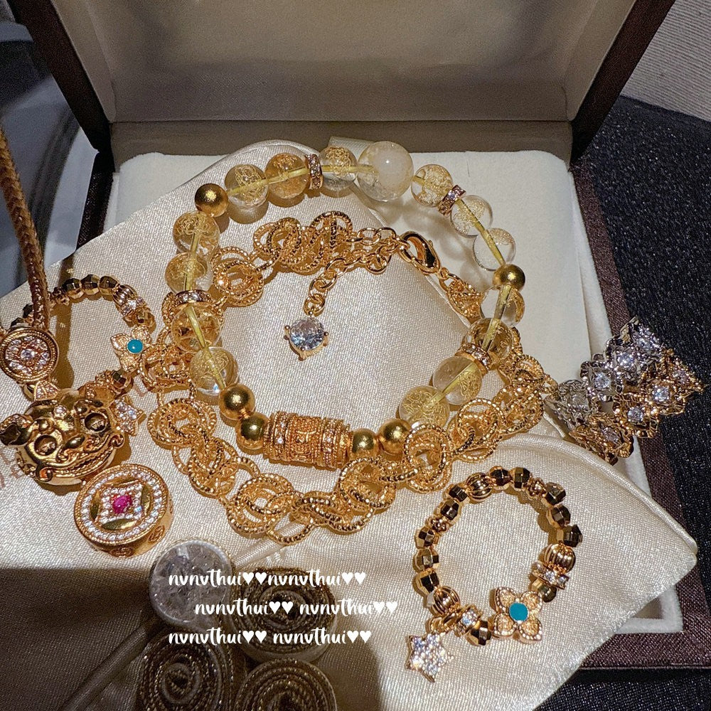 Golden Pi Xiu Wealth Bracelet Set — A luxurious Feng Shui jewelry collection featuring gold-plated Pi Xiu charms, citrine beads, and symbolic coin details designed to attract abundance, prosperity, and good fortune.