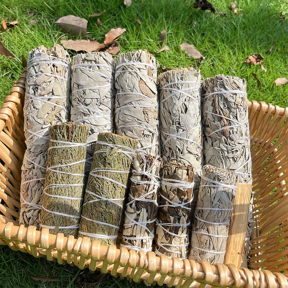 A natural smudge bundle featuring white sage, cedar, and herbal sticks — perfect for energy cleansing, purification rituals, and home blessing ceremonies.